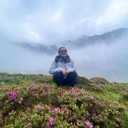 Woman on mountain with flowers