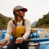 Woman rowing raft on river