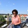 Student posing overlooking landscape of river and the city of Prague