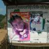 Public postings on a board with various posters and info in a foreign language