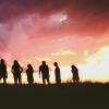 Silhouette of students standing on the horizon