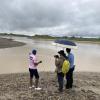 3 people looking at flooding
