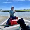 Man and dog in raft on river