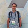 Man standing in front of graphics for ESRI event