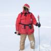 Man in red parka standing in snow