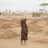 African woman standing in drought-affected area