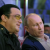 Vladimir Putin sits between actor Steven Seagal, left, and Russian mixed martial artist Fedor Emelianenko, right, at a martial arts competition in Russia in 2012. (Credit: CC photo via Wikimedia Commons)