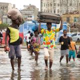 Displaced persons flee the aftereffects of 2019’s Cyclone Idai in Mozambique.