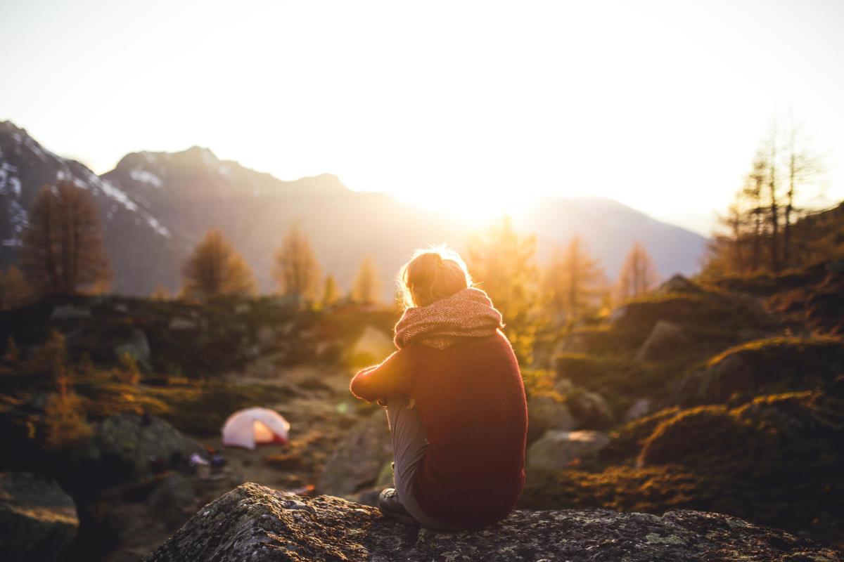Person camping at sunset