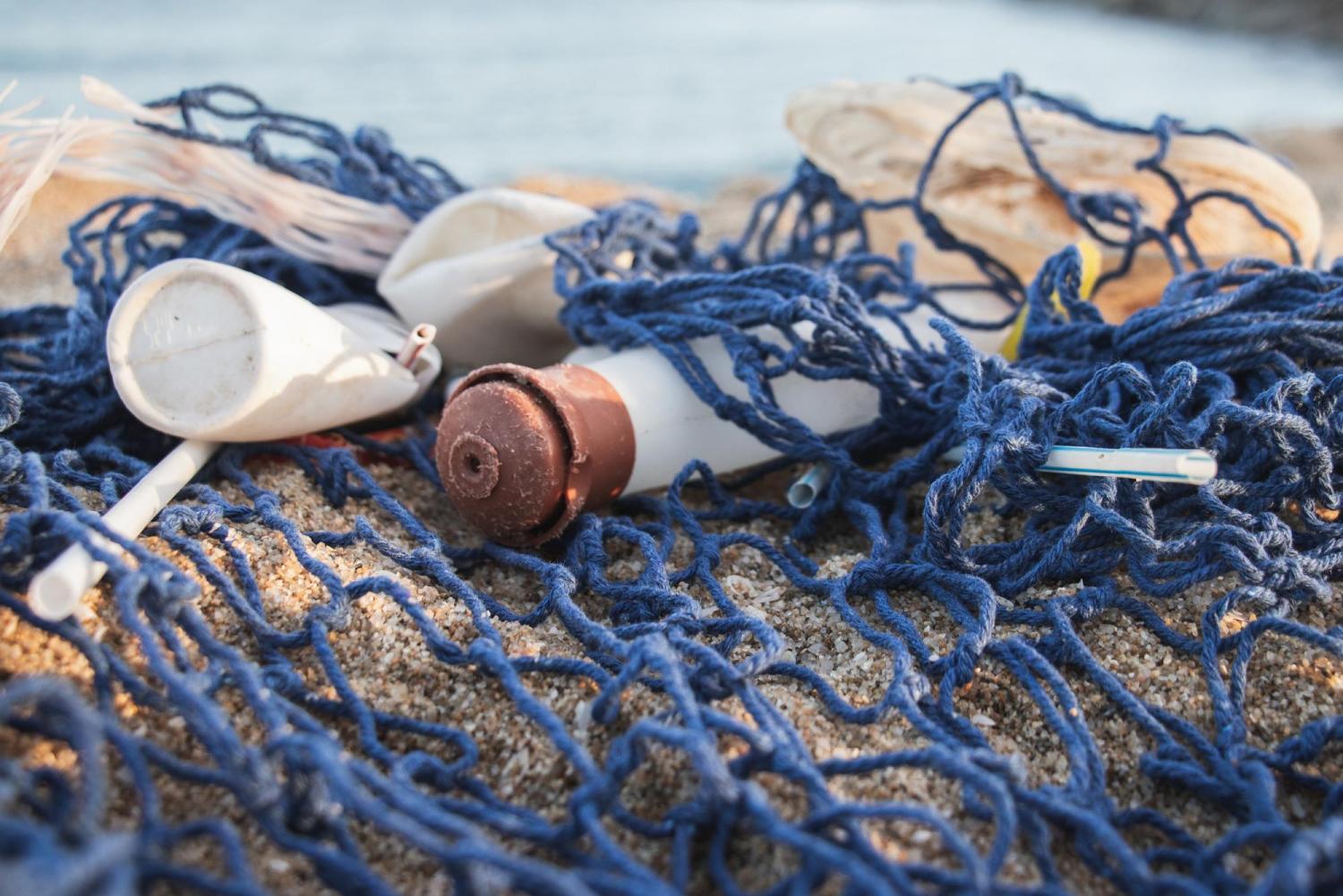 Plastic trash caught in fishing net on beach