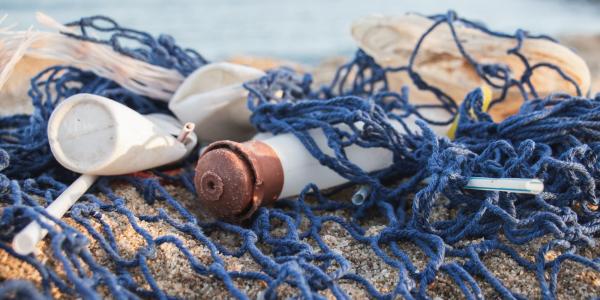 Plastic trash caught in fishing net on beach