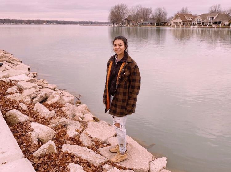 Tia Kennedy standing at edge of water