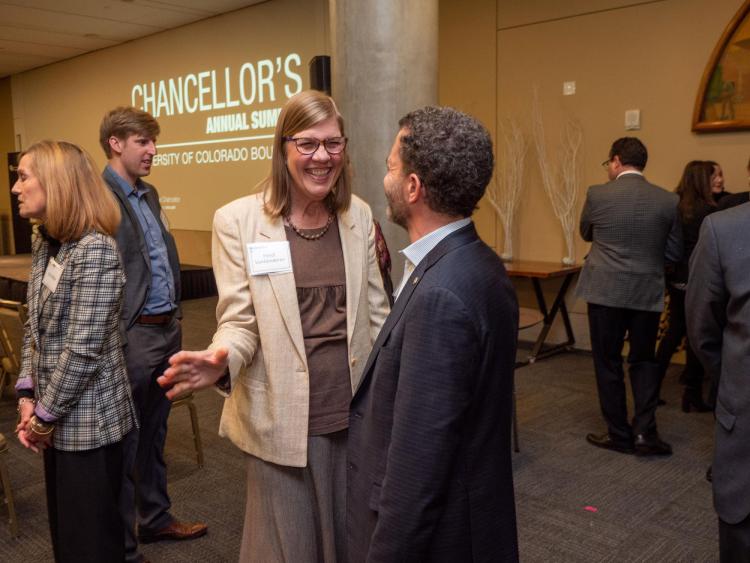 Heidi VanGenderen talks with President Todd Saliman.