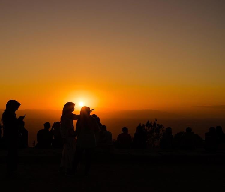 People in silhouette at sunset