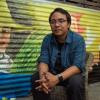 Yeb Saño sitting in front of mural