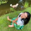 Tia Kennedy with her dog wading in stream