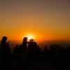 People in silhouette at sunset