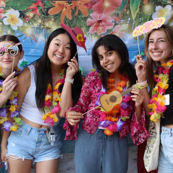 Group of Students Using Photo Booth at Luau 