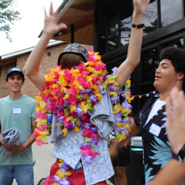 Student wearing  a lot of Hawaiian  Leis at the Luau 