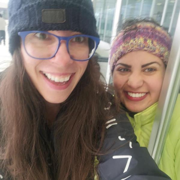 Two grad students smile in close up on ice