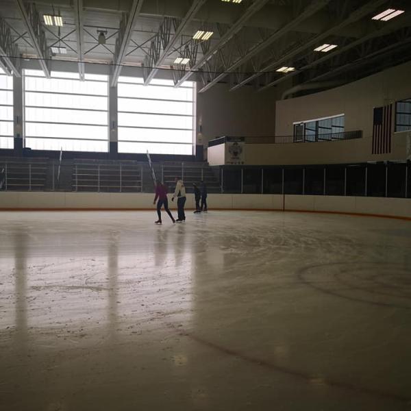 View from afar of three students skating