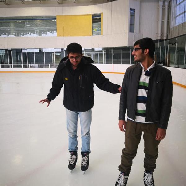 Two grad students ice skate