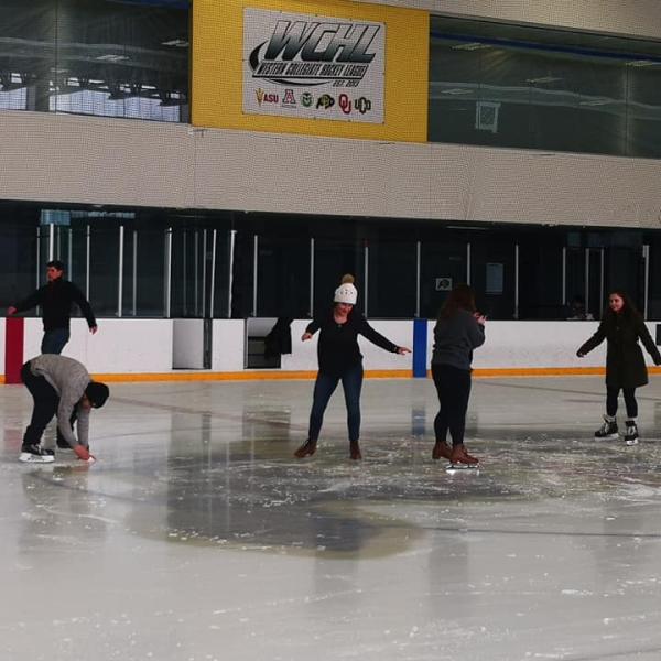 Several students skate at center of rink