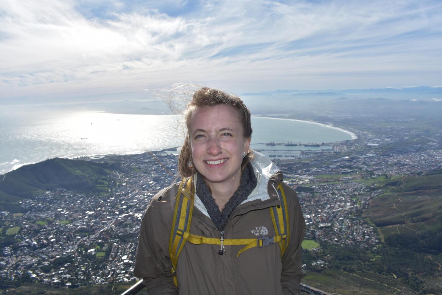 Emily standing high above a town and body of water