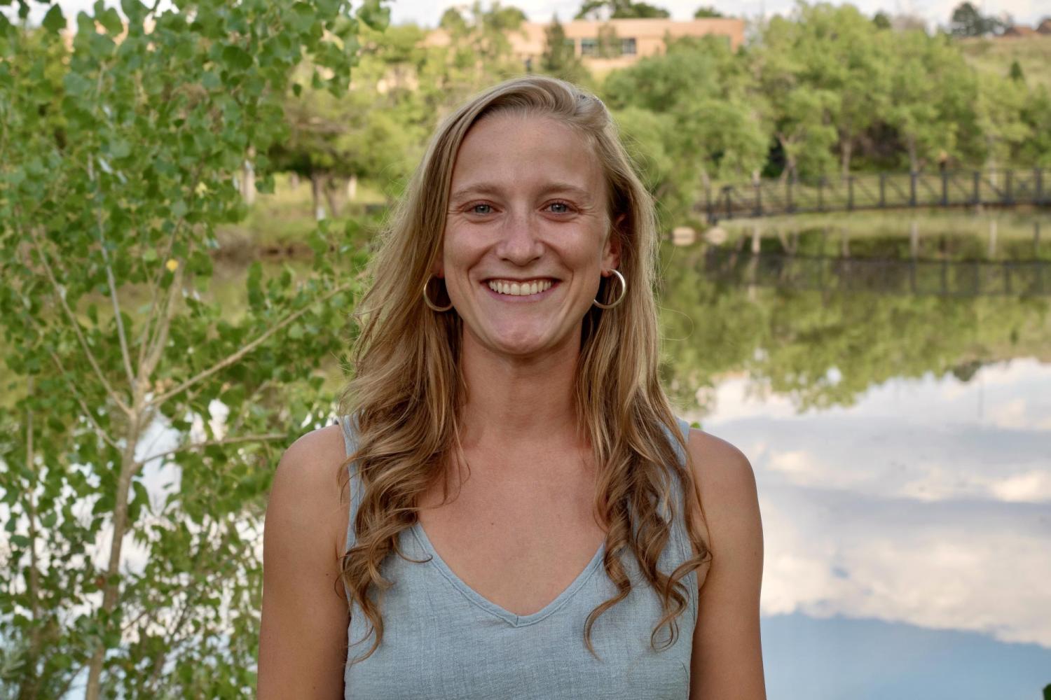 Georgia standing in front of a pond with trees