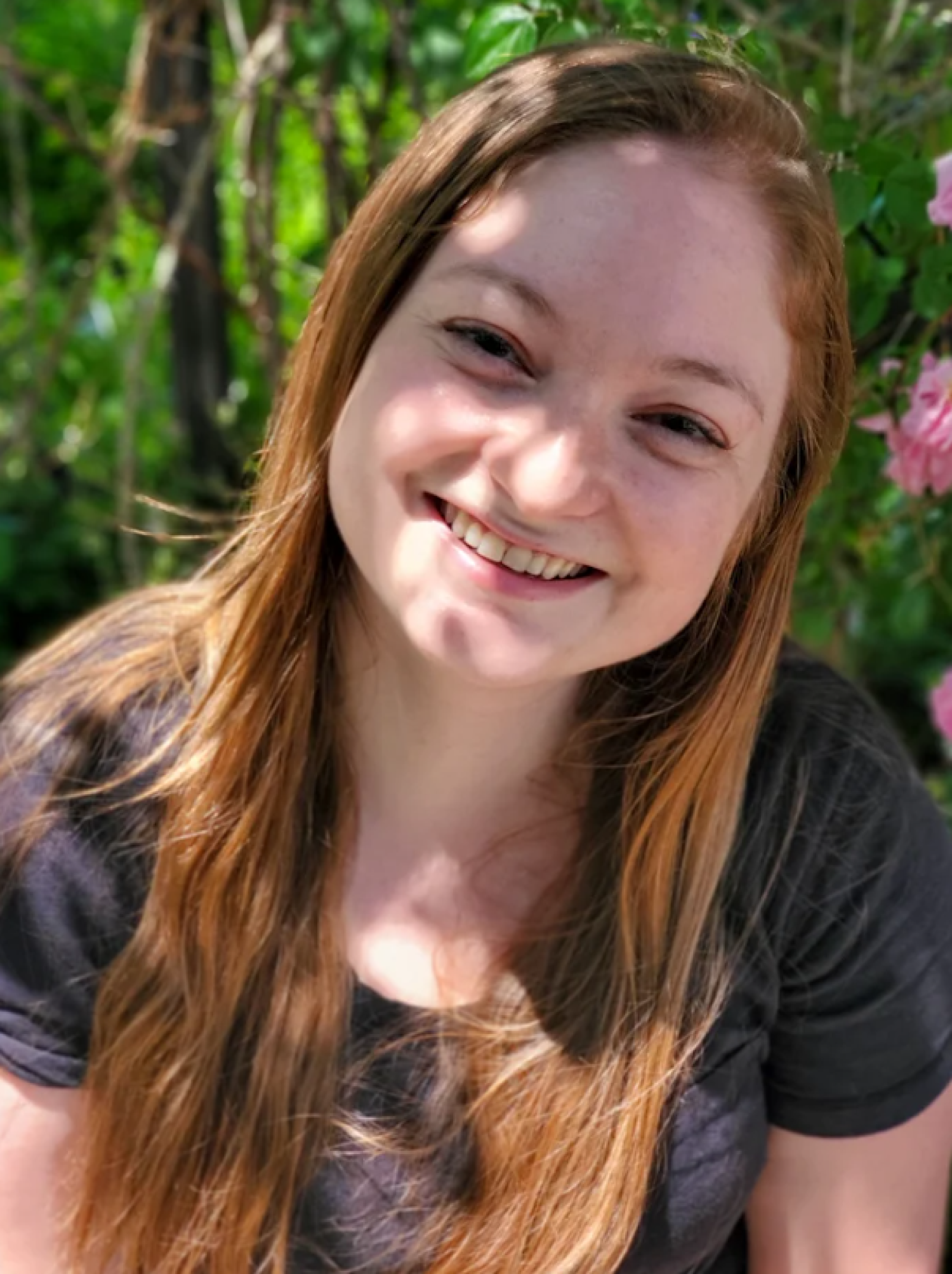Headshot of Hillary in front of greenery