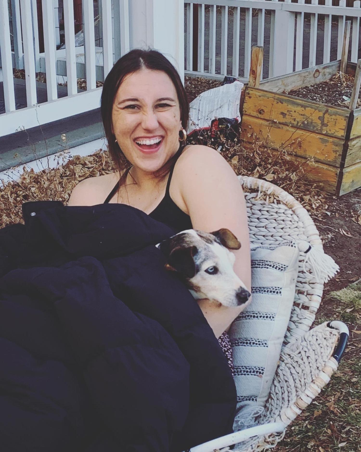 Niki laughing with a dog