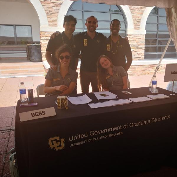 UGGS officers standing behind table at resource fair