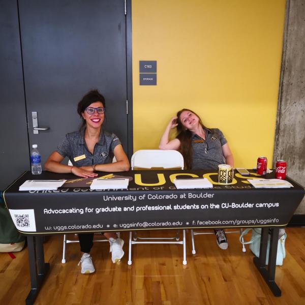 UGGS officers sitting at information table at social