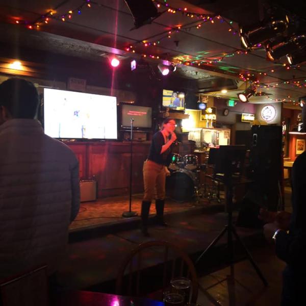 A solo karaoke performer in boots brings down the house