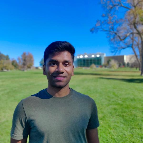 Chris outside with blue sky and green grass