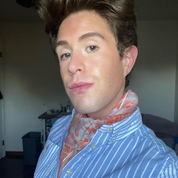 Image of jason wearing a scarf and blue shirt