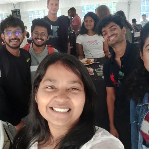 A group of students take a photo together during the peer mentor meet and greet