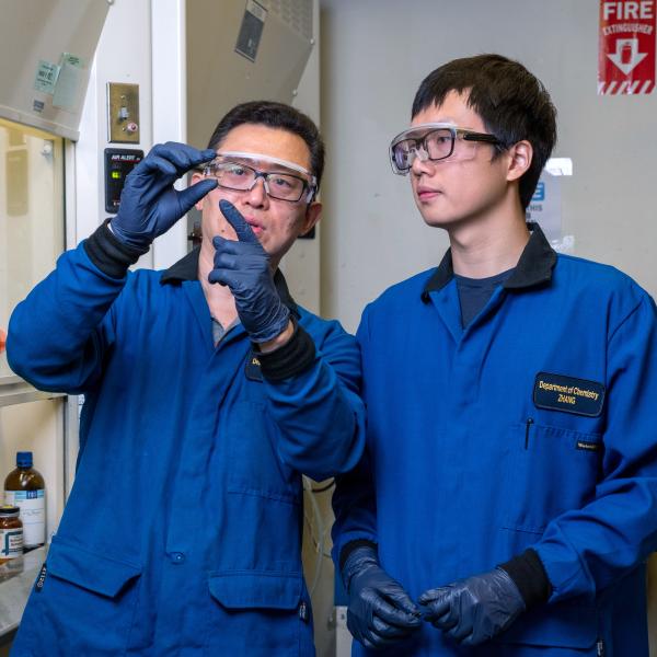 Chemist Wei Zhang with a student in his lab