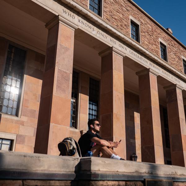 Student sitting outside of Norlin Library