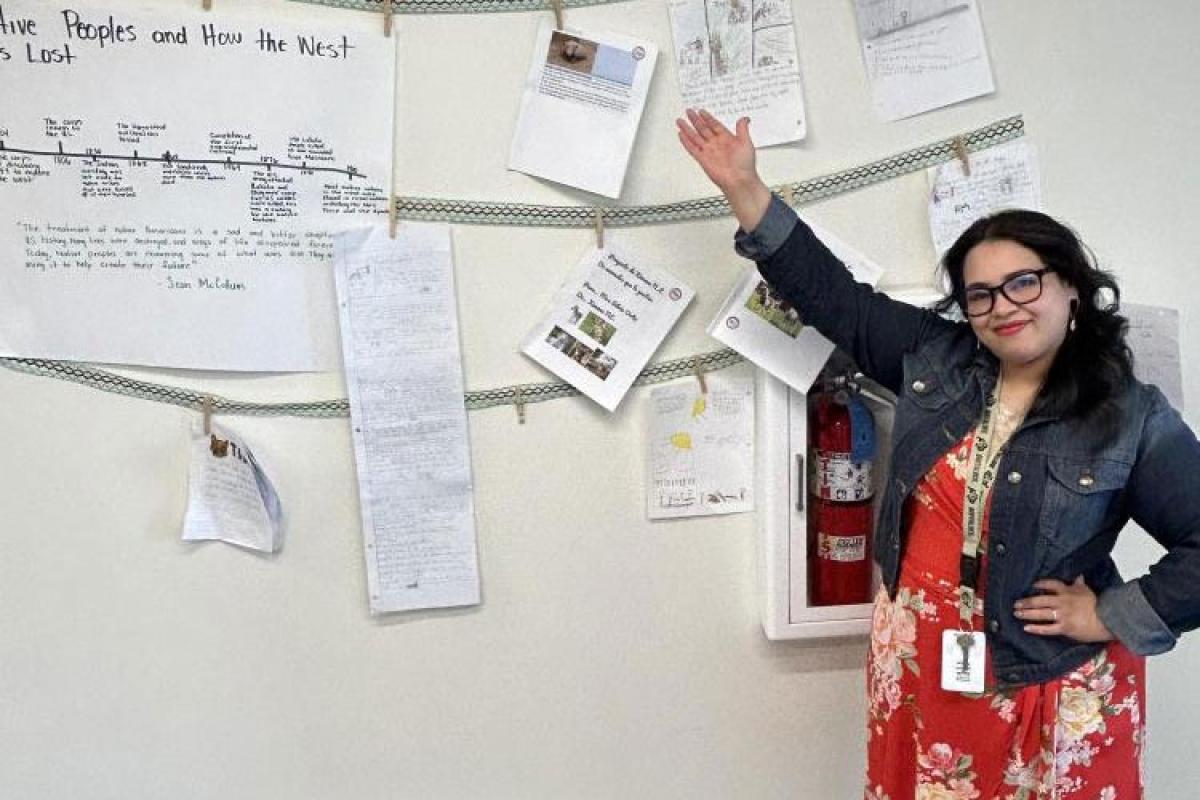 Silvia Ortiz pointing out her project on the wall