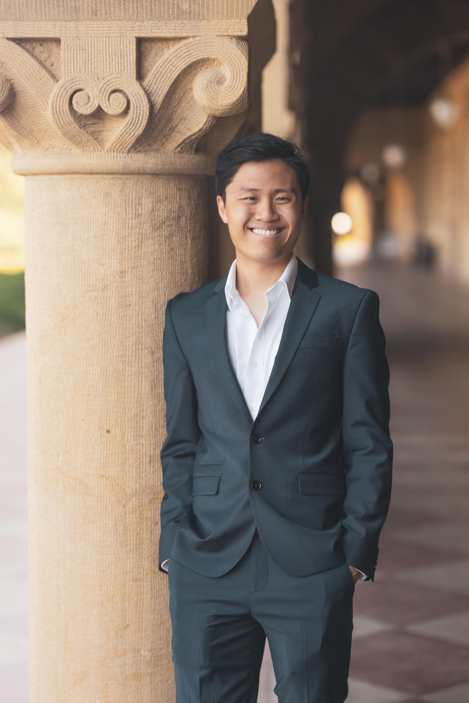 Tuan Anh Nguyen standing beside a column