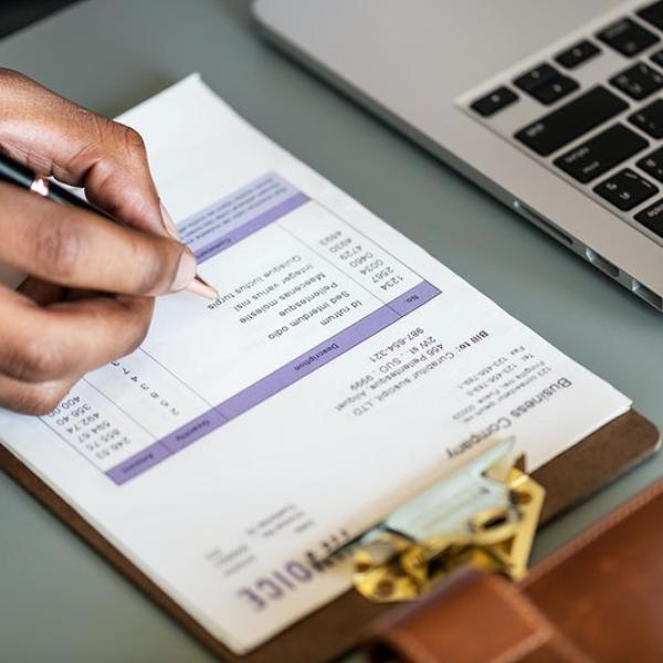 A person writing on a clipboard