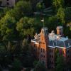 Aerial photo of Old Main surrounded by trees