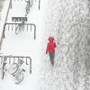 Student walking on a snowy path on campus