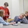 Professor talking with students in a classroom
