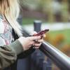 A young woman playing with her phone
