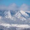 Snowy flatirons with a blue sky in the back
