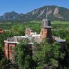 Aerial photo of Old Main with the Flatirons in the background