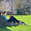Student reading a book in the Norlin Quad