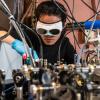 Qizhong Liang, a PhD candidate in JILA and the Department of Physics, poses in the lab.